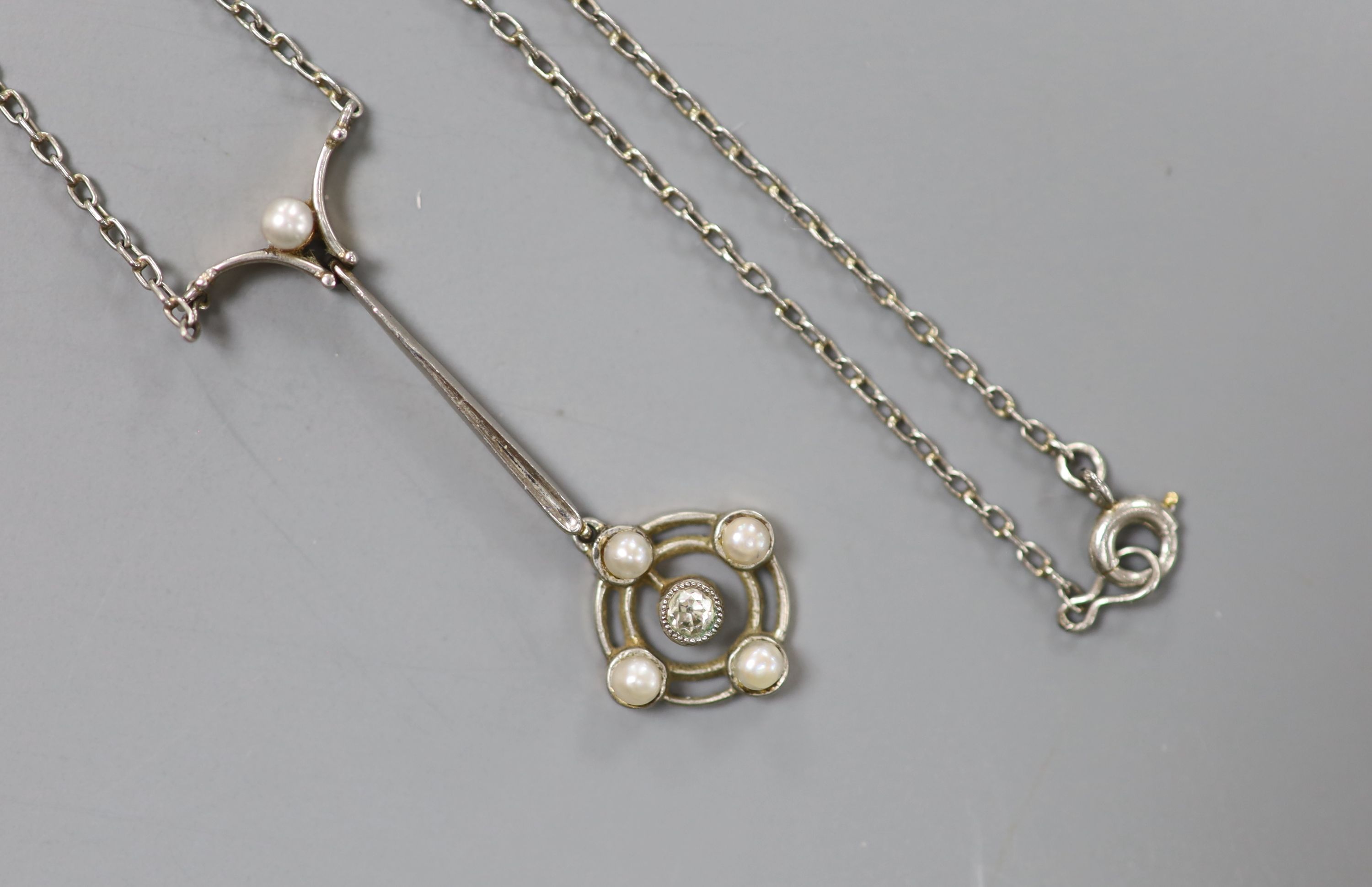 An Edwardian yellow and white metal, seed pearl and diamond set cluster drop pendant necklace